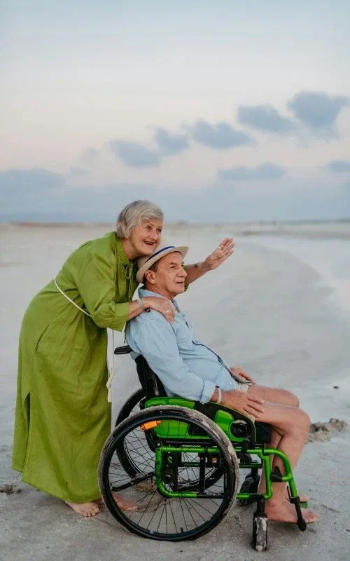 senior-man-on-wheelchair-enjoying-together-time-with-his-wife-at-sea--retsqb4z1glqxl5zonbmrjldouudt42yx59j8ydg00